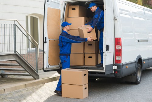 Company van and staff preparing to load items