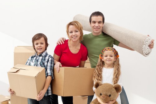 Experienced movers carefully packing household items
